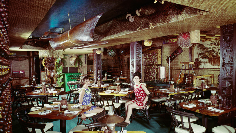 Vintage photo of two tropical-clad workers of the Beachcomber tiki restaurant