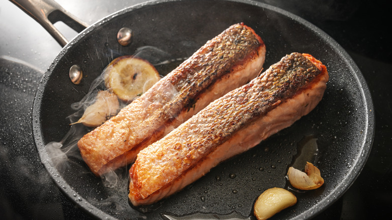Salmon searing on a pan