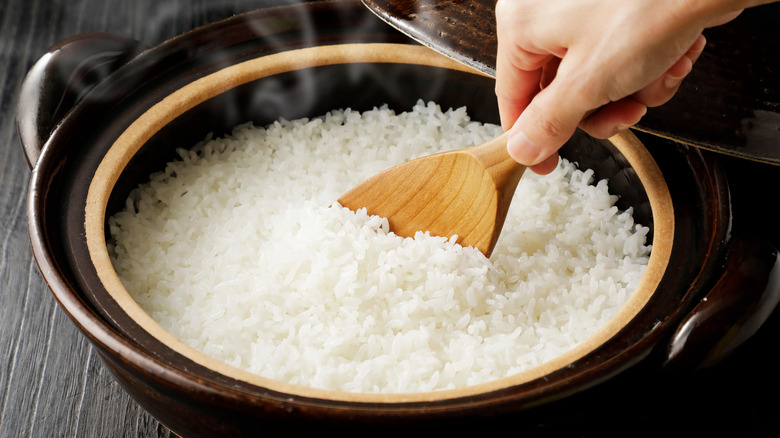 wooden spoon scooping white rice