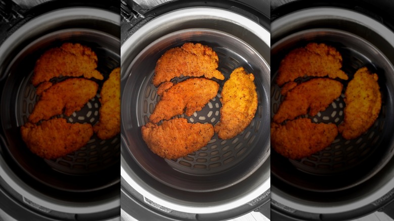 Chicken cutlets in an air fryer basket