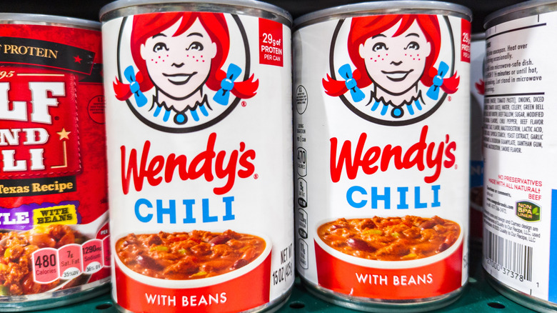 Cans of chili on store shelf