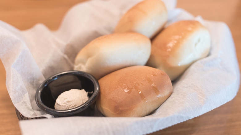 Texas Roadhouse rolls in basket with cinnamon-honey butter
