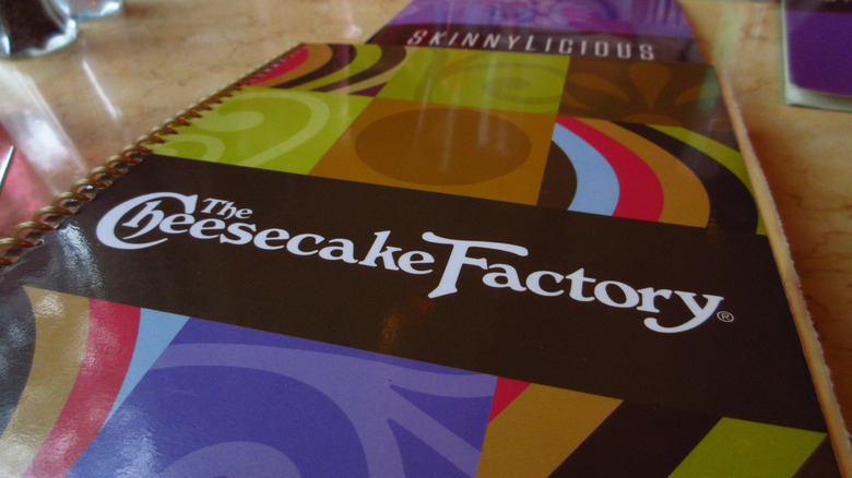 Cheesecake Factory menu on restaurant table.