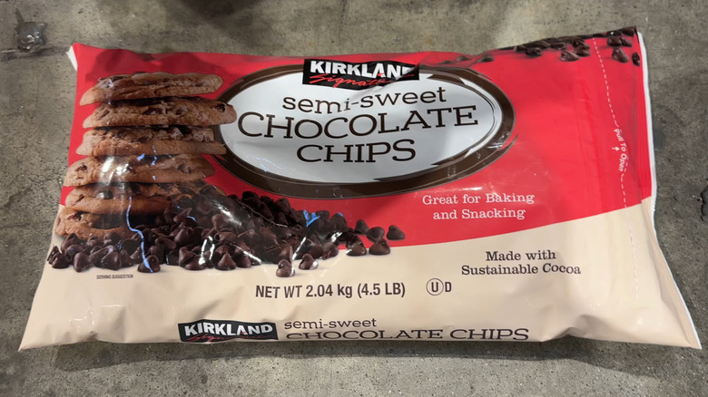 A bag of Kirkland Signature Semi-Sweet Chocolate Chips rests on a grey surface