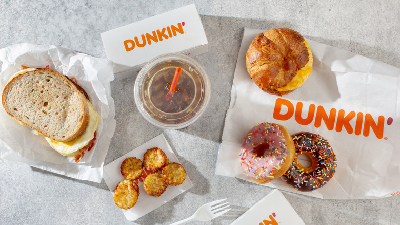 top down view of breakfast sandwiches donuts and coffee