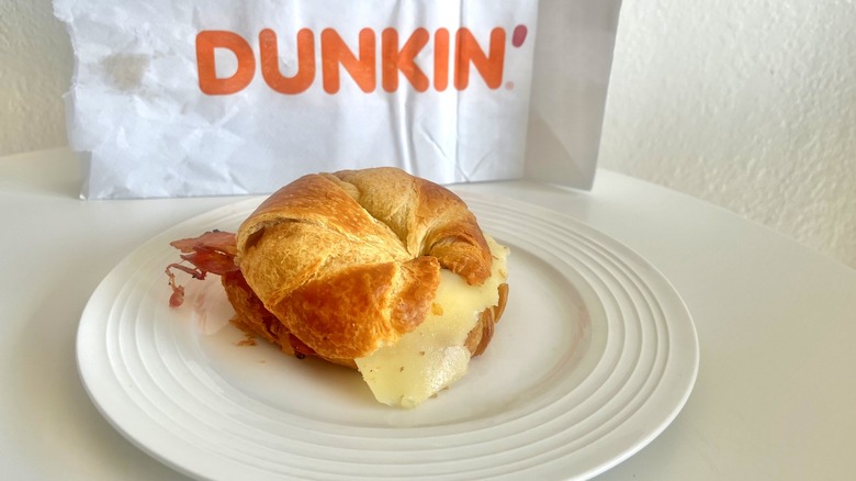 Dunkin's sweet black pepper bacon sandwich on a white plate