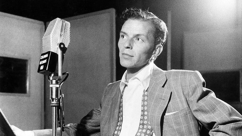 Frank Sinatra standing at microphone