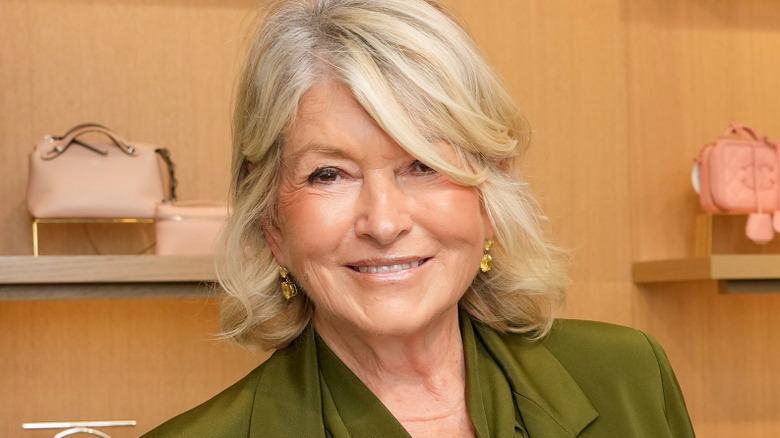 Martha Stewart signing one of her books at an event
