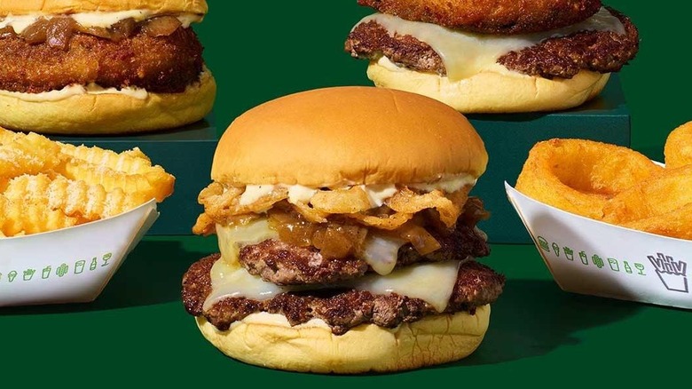 A Shake Shack French Onion Soup Burger with other sandwiches onions and fries