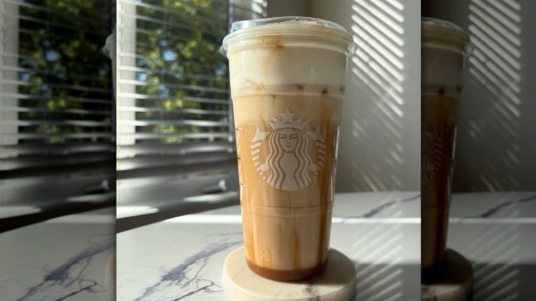 Close-up of a layered Iced Pecan Crunch latte from Starbucks