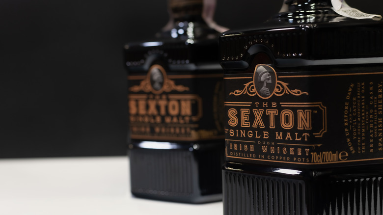 Closeups of Sexton whiskey bottles showing the labels