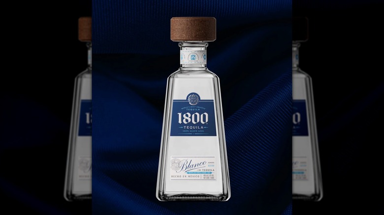 Bottle of 1800 Blanco Tequila on a velvet blue background