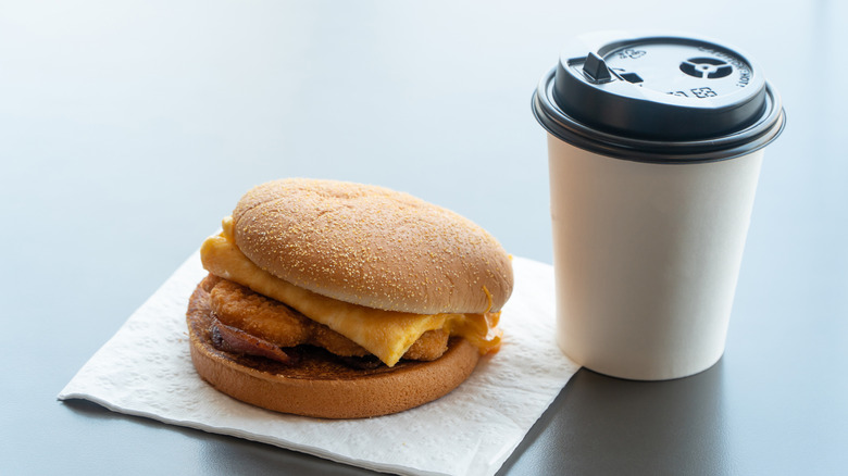 breakfast sandwich and coffee in a to-go cup