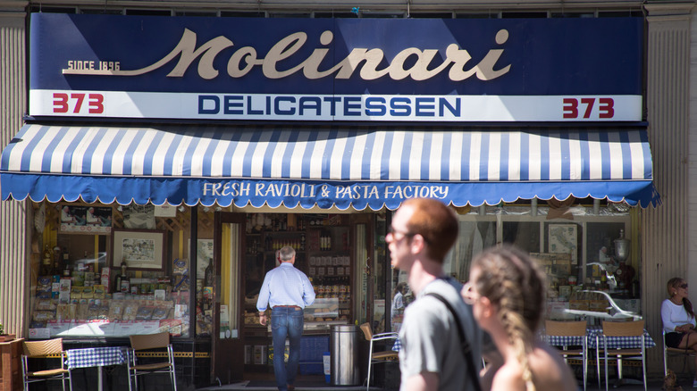 Molinari Deli Storefront with outdoor seating under blue and white awning