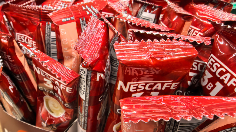 Red packets of Nescafe instant coffee in a box.