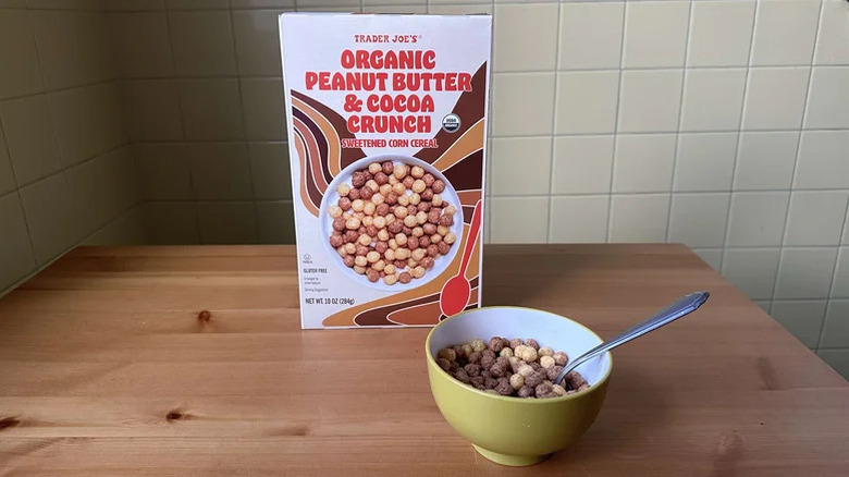 Box of Trader Joe's Organic Peanut Butter Cocoa Crunch cereal next to a bowl of it