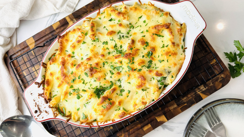 Chicken Alfredo bake in oval baking dish