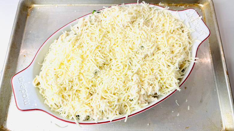Pasta bake topped with shredded cheese in baking dish