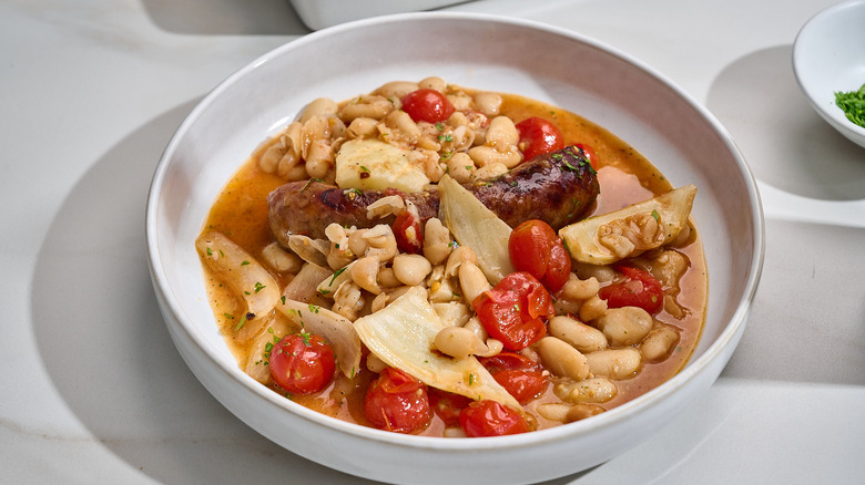 sausage and beans in a bowl with tomatoes