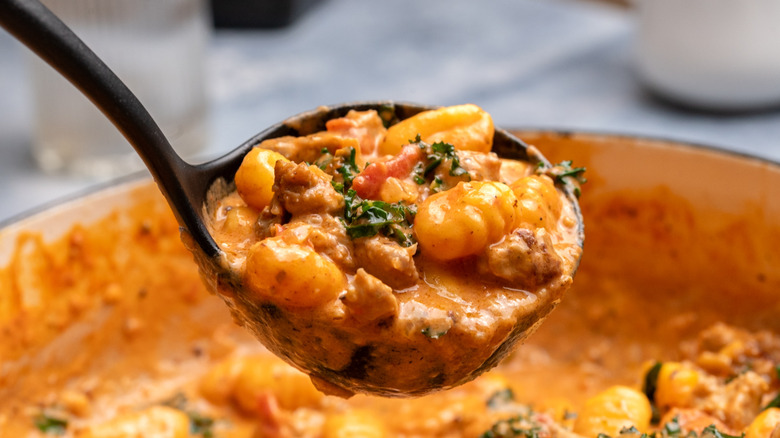 Ladle of sausage and gnocchi