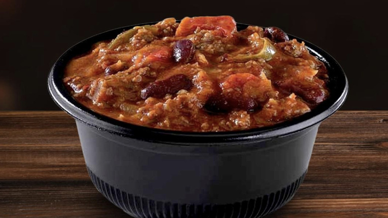 A bowl of Firehouse Subs chili in a takeout bowl.