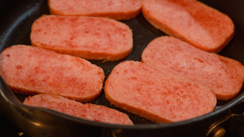 Slices of Spam on a frying pan