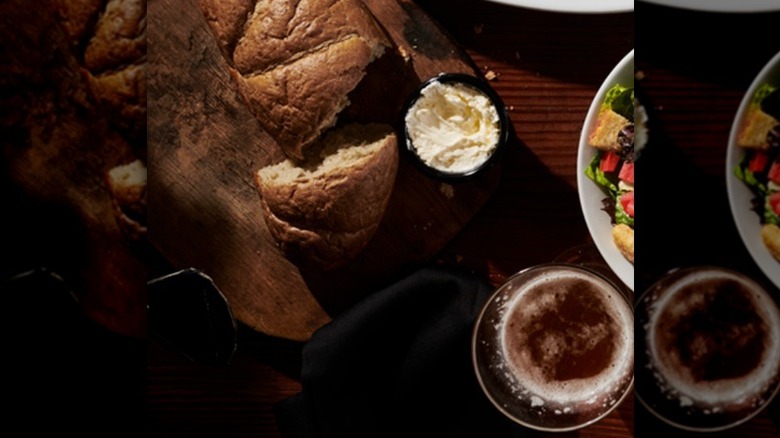 LongHorn Steakhouse bread with butter, drink, and salad