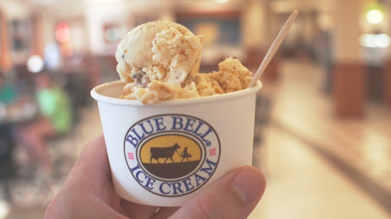 Someone holding a scoop of Blue Bell ice cream