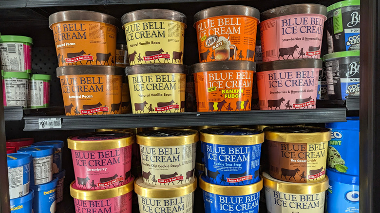 half gallons of Blue Bell ice cream in various flavors in freezer aisle