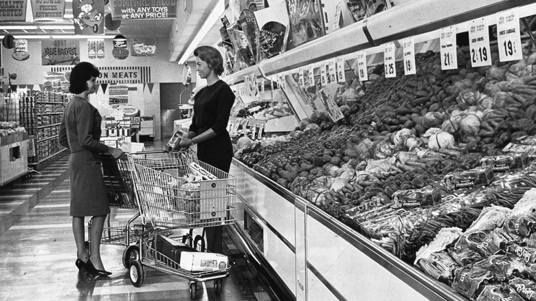 shoppers standing in aisle in '60s