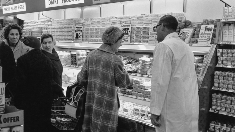 clerk helping grocery customer