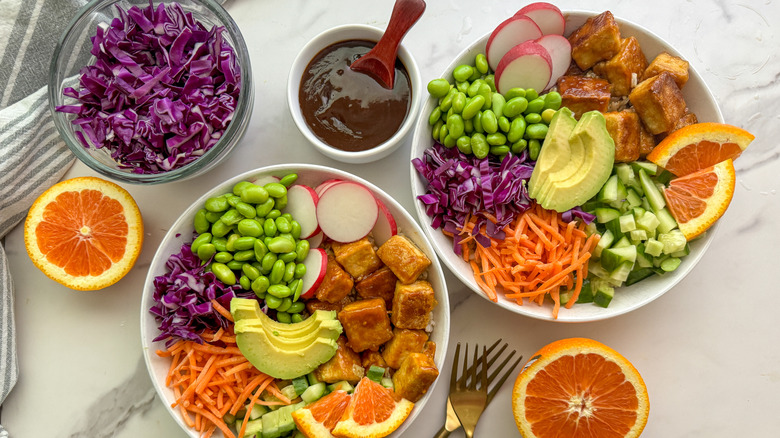 orange tofu rice bowls with colorful vegetables
