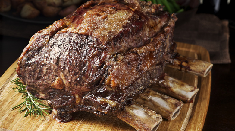 Perfectly roasted prime rib on wooden cutting board