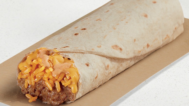 Cheesy Bean and Rice Burrito on brown paper with white backgroudn