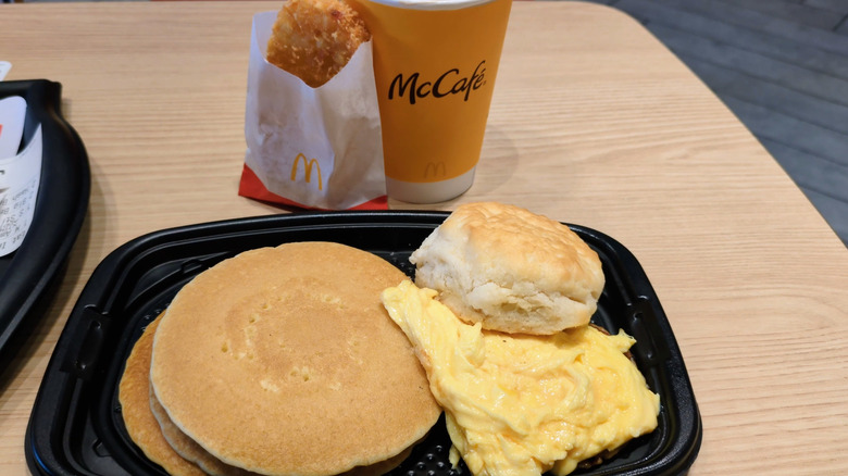 Assorted McDonald's breakfast items sitting on a wooden table