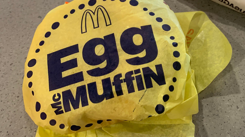 A wrapped McDonald's Egg McMuffin sandwich