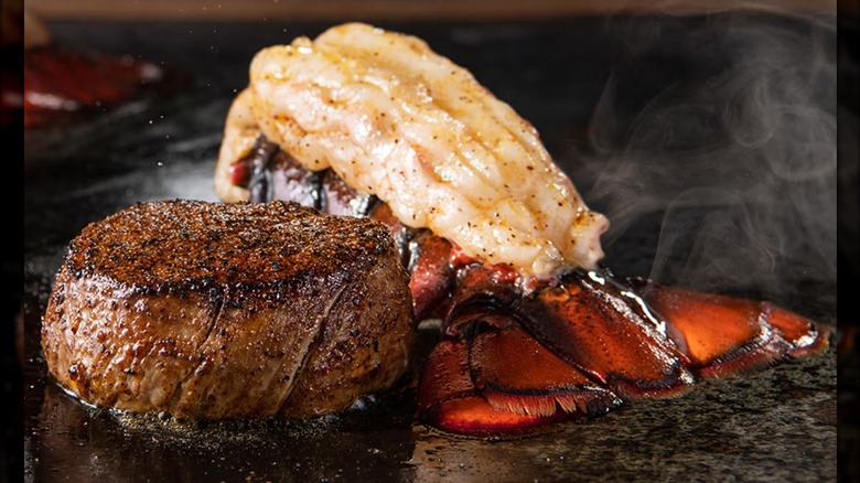 LongHorn Steakhouse's 6-ounce Flo's Filet with 4-ounce Lobster Tail sitting on a steamy black plate