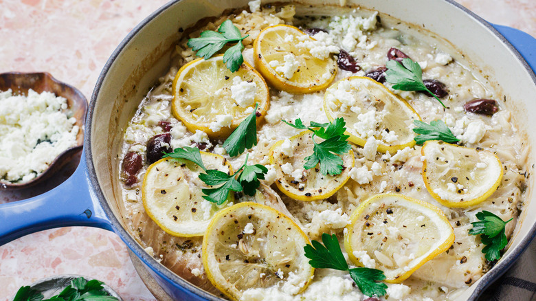 Large blue pot of orzo and fish with feta and parsley