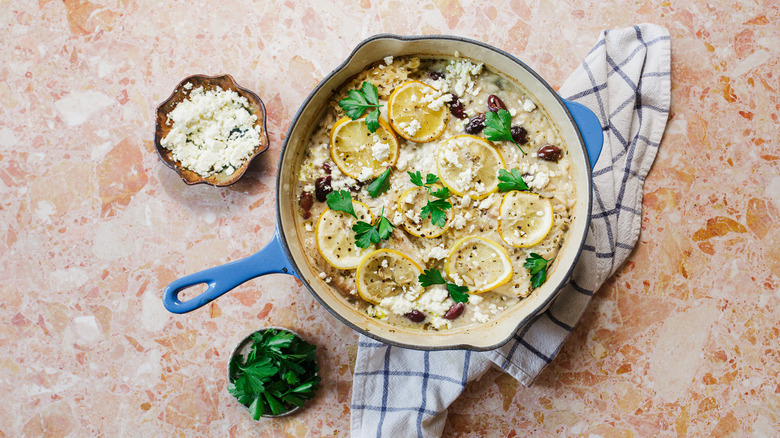 Large blue pot of orzo and fish with feta and parsley