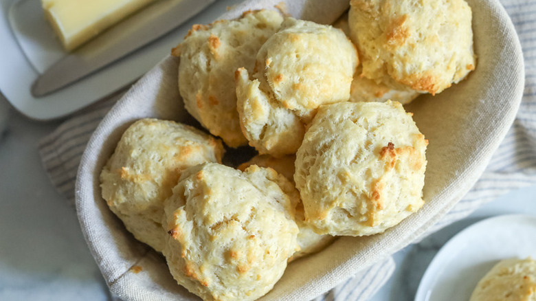 Pile of drop biscuits in linen-lined bowl