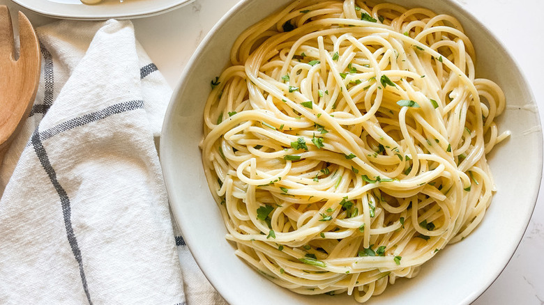 Bowl of garlic butter noodles garnished with parsley