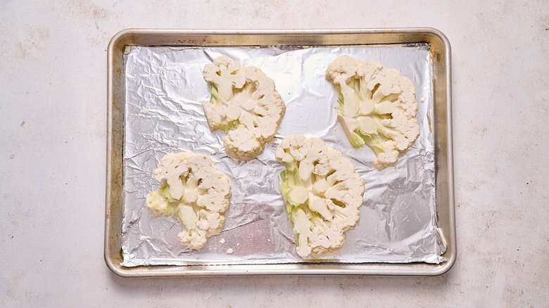 cauliflower steaks on a baking sheet