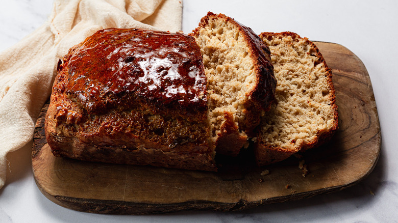 Honey-glazed beer bread on cutting board with napkin