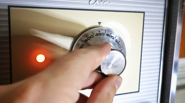 hand on oven dial