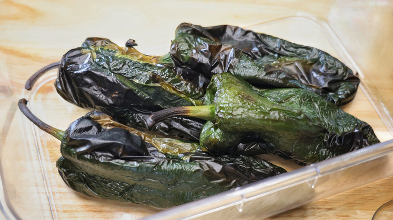 roasted poblano peppers in a clear plastic container