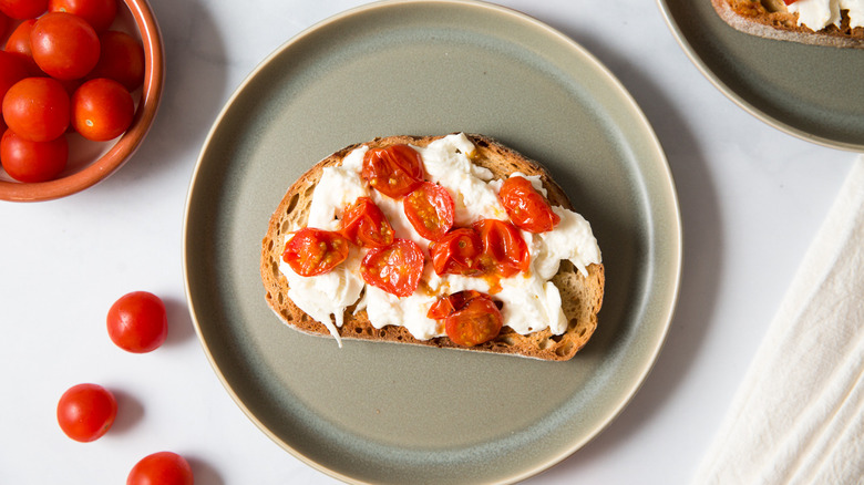 burrata toast on green plate