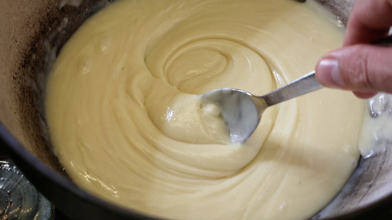 spoon stirring pot of white chocolate fudge