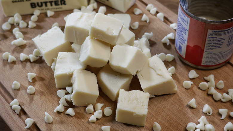 pile of white chocolate fudge pieces on a wooden cutting board