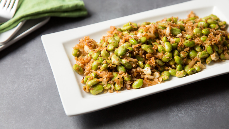 sauteed edamame served on table