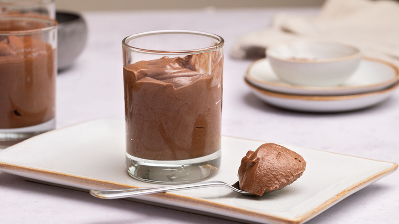 Chocolate mousse in small jar and on spoon